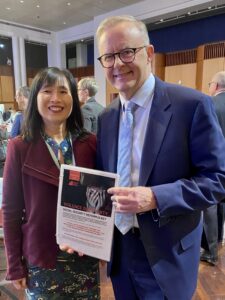 Prime Minister Anthony Albanese with Leanne Ho (Economic Justice Australia) holding the Legislative Brief